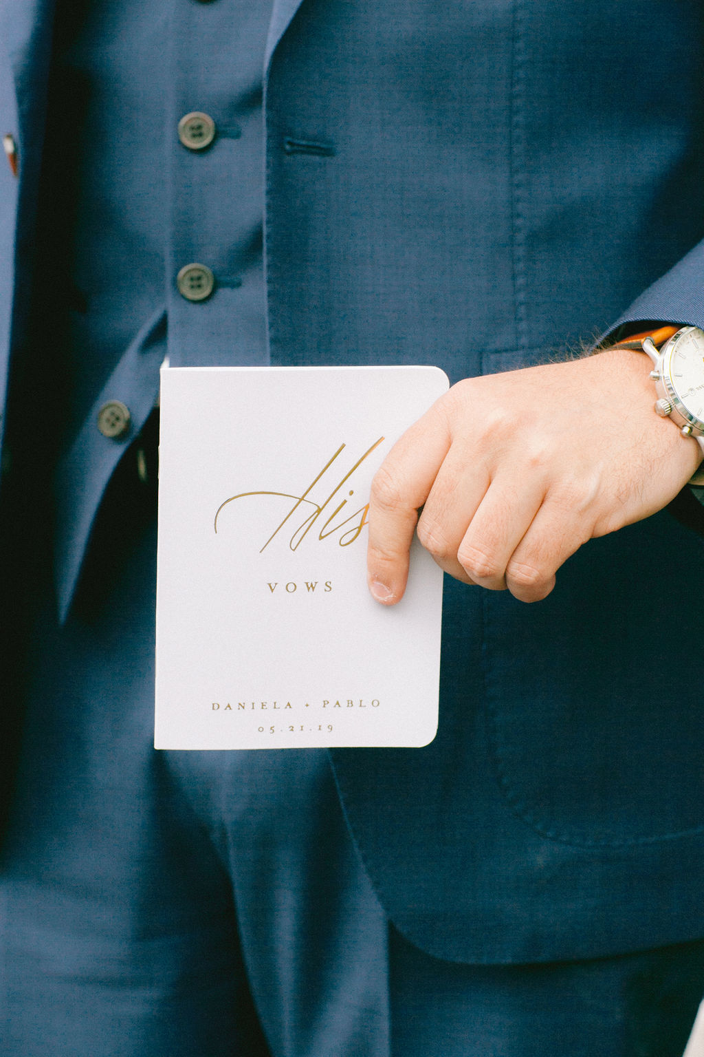 A groom holding his vow book