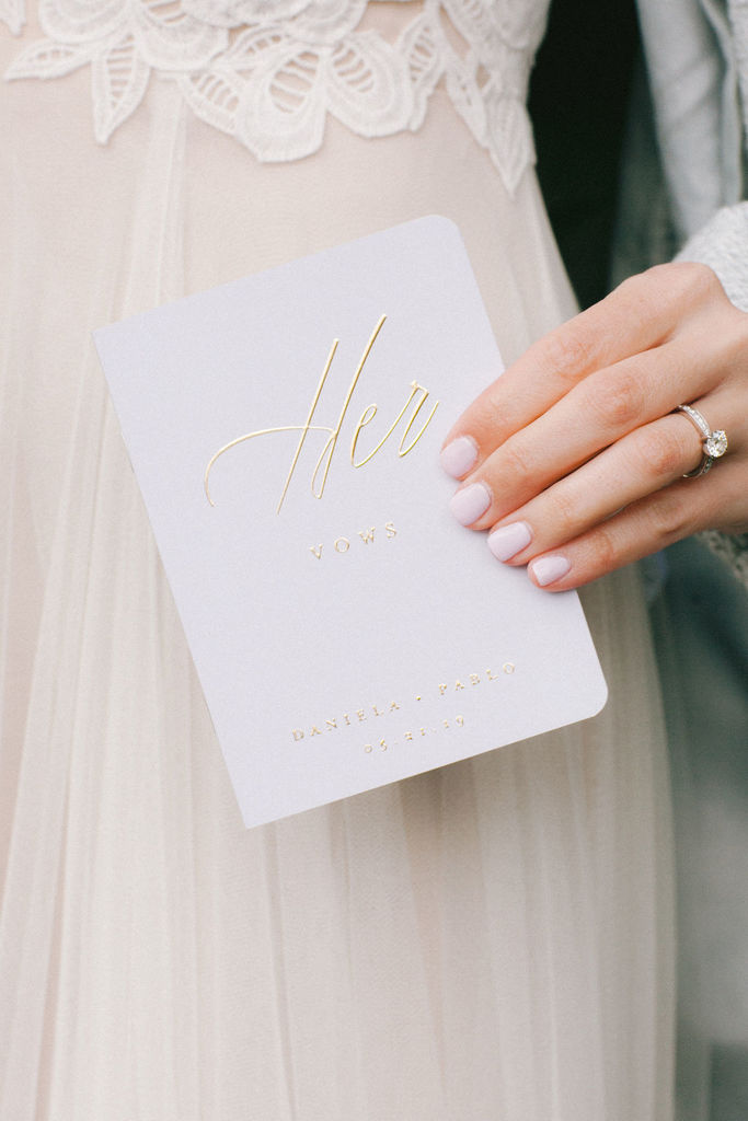 A bride holding her vow book