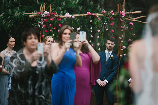 wedding guests with mobiles